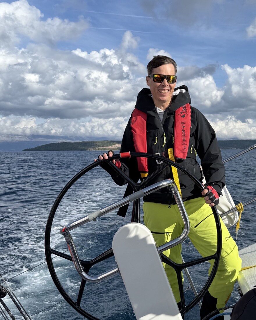 Björn Bösenberg at the helm of a sailing yacht